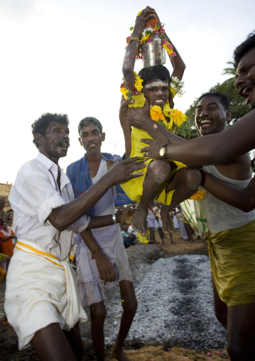 Little Boy With Yellow Clothes Carried By Men Succeeding At Fire Walking In Tamil Nadu, Madurai, South India