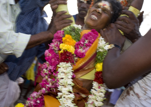 Suffering Woman Wearing Flower Garland Supported By The Crowd During Fire Walking Ritual, Madurai, South India