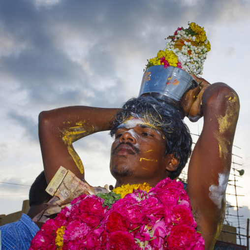 Young Man With Ashes And Yellow Paste On His Body Carrying Offerings Ready For Fire Walking Ritual, Madurai, South India