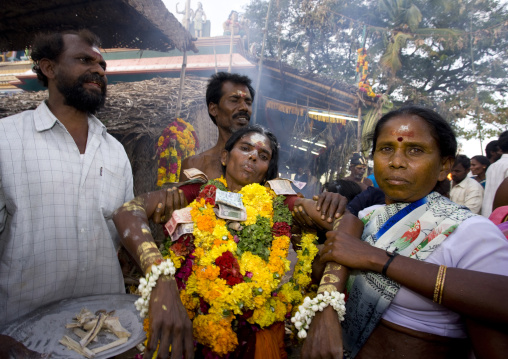 Weakened Women Covered By Ashes With Flower Garland And Bank Bills As Offerings Supported By A Man And A Woman At Fire Walking Ritual, Madurai, South India