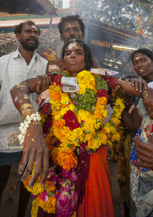Women Covered By Ashes With Flower Garland And Bank Bills As Offerings Supported By A Man At Fire Walking Ritual, Madurai, South India