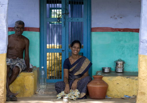 A Woman And A Man Sitting In Front Of A Colorful House, Madurai, India