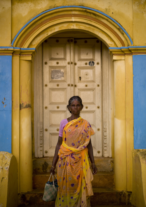 Indian Woman Holding A Handbag Posing In Front Of Her Coloful House In Kanadukathan Chettinad Street, India