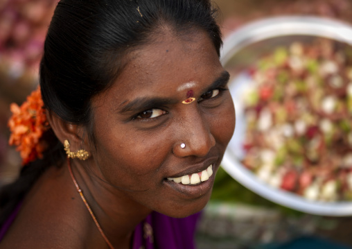 Woman With Bindi, Nose Piercing And Tied Hair With Flowers Smiling At The Camera, Madurai, India