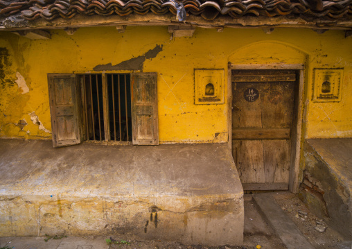 Front Of An Old, Little And Decrepit House With Yellow Wall, Chennai, India