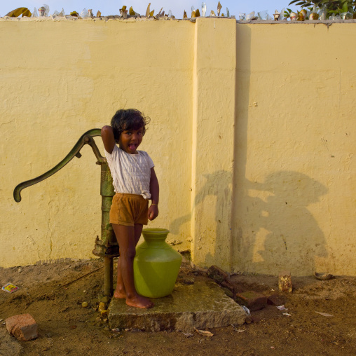 Smiling Little Girl With A Pitcher Of Water In Front Of A Water Well, Mahabalipuram, India