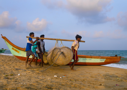 Fishermen Using A Wooden Stick To Carry Their Nets On Mahabalipuram Beach, India