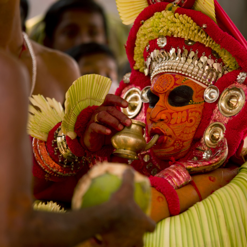 Theyyam Dancer Drinking An Offering Drink During The Ceremony, Thalassery, India