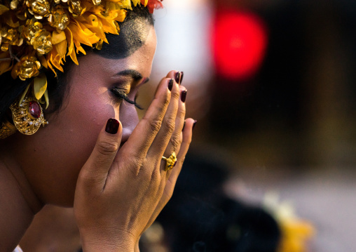 A Teenager Girl In Traditional  Costume Praying Before A Tooth Filing Ceremony