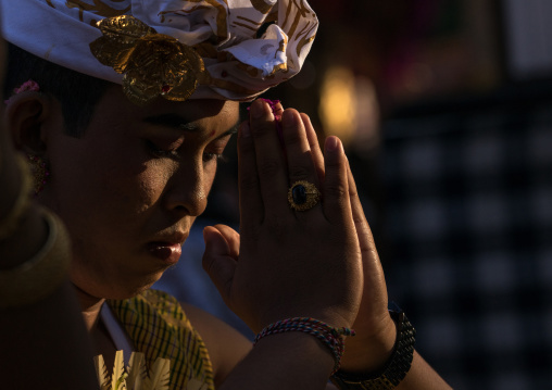 A Teenager Boy In Traditional  Costume Praying Before A Tooth Filing Ceremony