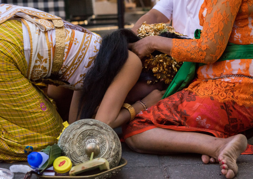 A Teenager Girl In Traditional  Costume Paying Respect To Her Mother Before A Tooth Filing Ceremony