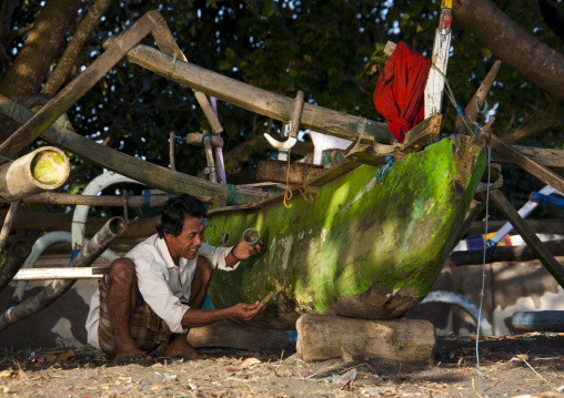 Man Repairing A Boat, Lombok Island, Indonesia