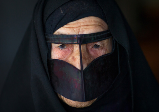 an old bandari woman wearing a traditional mask called the burqa, Qeshm Island, Salakh, Iran