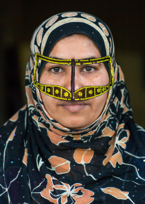 a bandari woman wearing a traditional mask called the burqa with a moustache shape, Qeshm Island, Salakh, Iran
