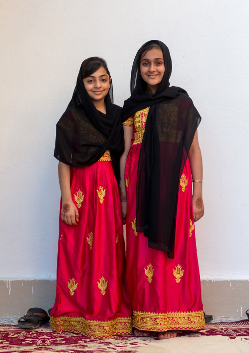 portrait of two young girls in traditional bandari clothing during a ceremony, Hormozgan, Bandar-e Kong, Iran