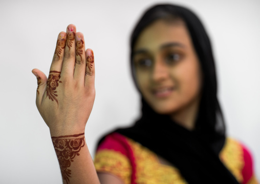 portrait of a young girl with henna tattooed hand in traditional bandari clothing, Hormozgan, Bandar-e Kong, Iran