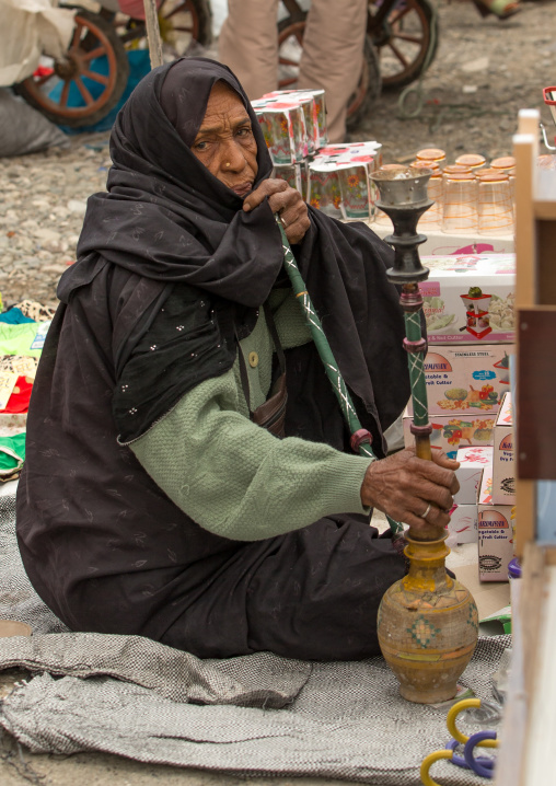 bandari woman smoking pipe at the panjshambe bazar thursday market, Hormozgan, Minab, Iran