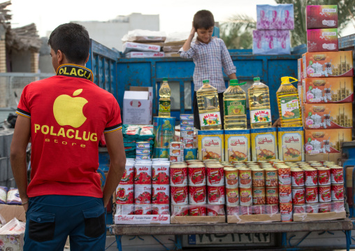 man with an apple logo on his shirt in panjshambe bazar, Hormozgan, Minab, Iran