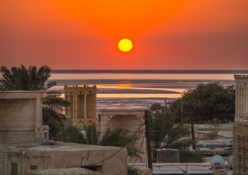 sunset over wind towers used as a natural cooling system in iranian traditional architecture, Qeshm Island, Laft, Iran