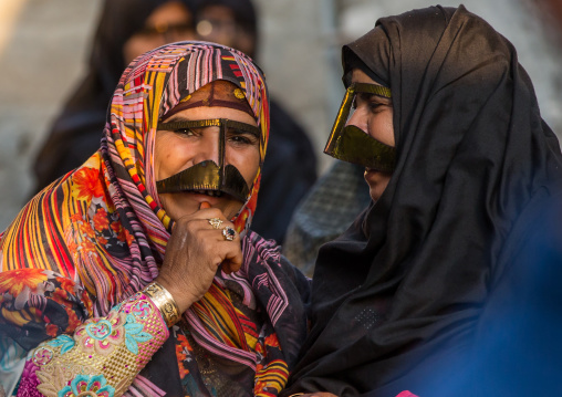 bandari women wearing the traditional masks called the burqas with a moustache shape, Qeshm Island, Salakh, Iran