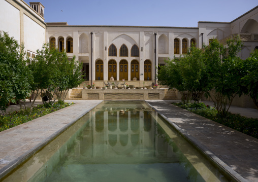 Reflections of manouchehri house on water pools, Isfahan province, Kashan, Iran