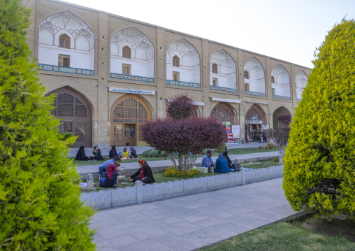Iranian people resting in naghsh-i jahan square, Isfahan province, Isfahan, Iran