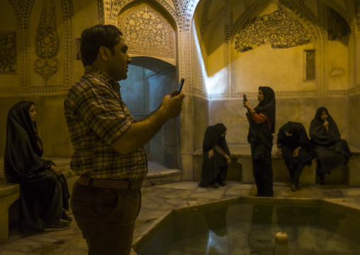 Man taking pictures in the karim khan fort bath, Fars province, Shiraz, Iran