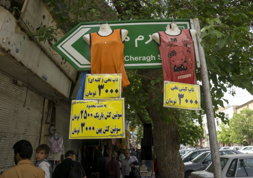 Shirts hanging on a sign in the street, Fars province, Shiraz, Iran