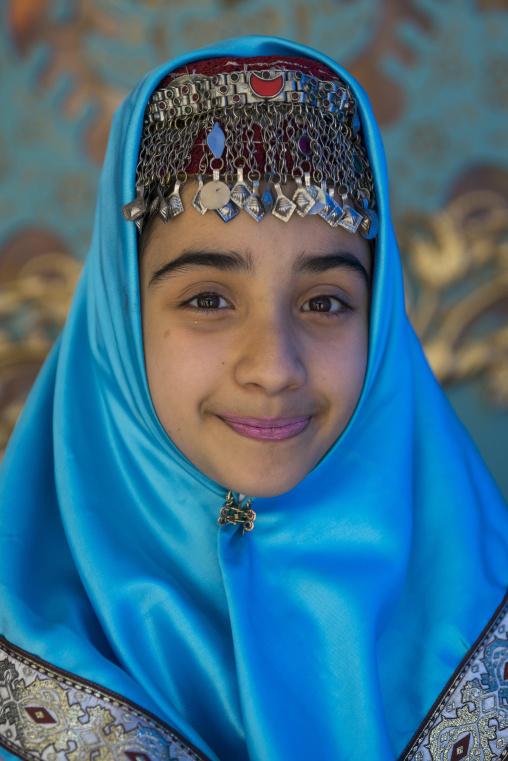 Girl pausing in traditional clothing for a photo souvenir in the saadabad palace, Shemiranat county, Tehran, Iran