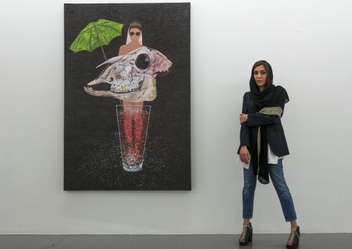 Elnaz pausing in front of her painting, Shemiranat county, Tehran, Iran