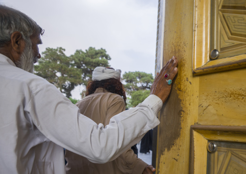 Pakistani touching the door of the shrine of fatima al-masumeh, Qom province, Qom, Iran