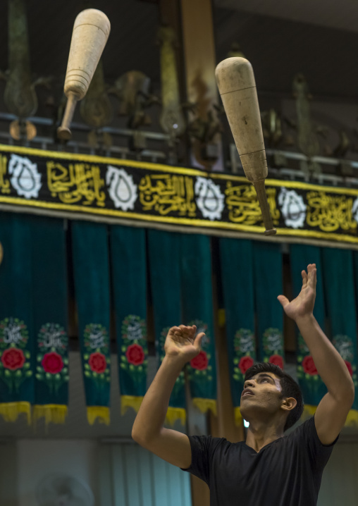Men wielding wooden clubs during the traditional sport of zurkhaneh, Isfahan province, Kashan, Iran