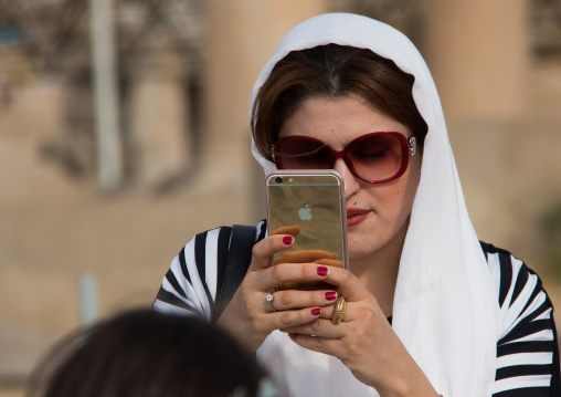 iranian woman taking pictures with an iphone, Central district, Tehran, Iran