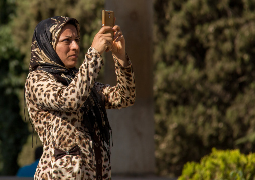 iranian woman taking pictures with a mobile phone, Central district, Tehran, Iran