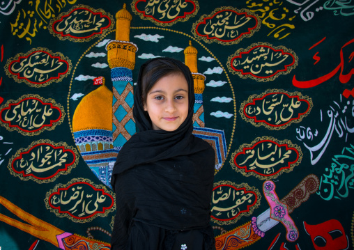 Portrait of an iranian shiite muslim girl in front of a Muharram flag, Isfahan Province, Isfahan, Iran
