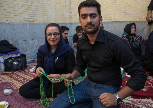 Iranian family who gives for free some prayer beads to mourners to see their wish happen, Isfahan Province, Isfahan, Iran