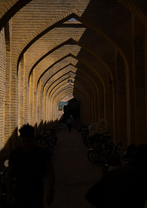Motorbikes parked along a narrow street with arches, Fars Province, Shiraz, Iran