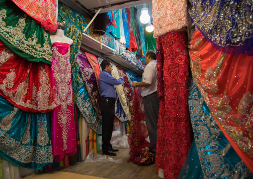 Man selling dresses in the clothes Bazaar, Fars Province, Shiraz, Iran