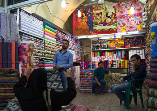 Man selling Disney stuff i the clothes Bazaar, Fars Province, Shiraz, Iran
