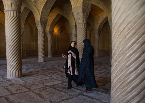 Two iranian shiite women in chadors inside Vakil mosque prayer hall, Fars Province, Shiraz, Iran