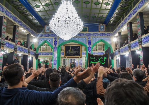 Iranian shiite muslim mourners chanting  during Muharram inside a hosseinieh, Yazd Province, Yazd, Iran