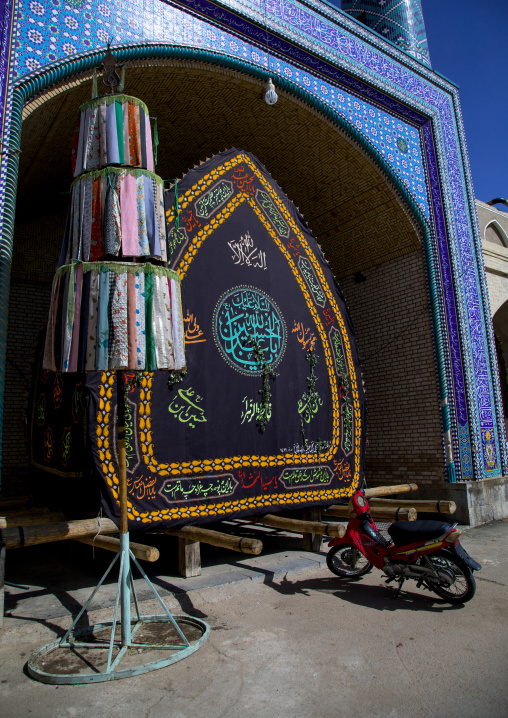 A nakhl and an alam made of clothes in front of a mosque during Muharram to commemorate the martyrdom anniversary of Hussein, Yazd Province, Yazd, Iran