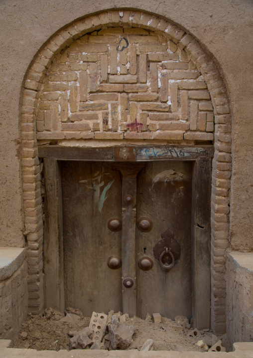 Old wooden door sinking in the ground, Yazd Province, Yazd, Iran