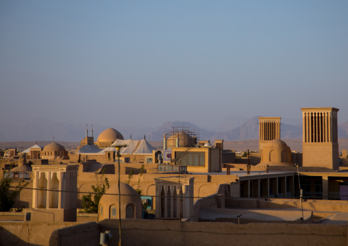 View of the city with traditional wind catchers and mosques at dusk, Yazd Province, Yazd, Iran