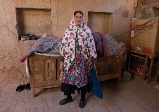 Portrait of an iranian woman wearing traditional floreal chador in her house, Natanz County, Abyaneh, Iran