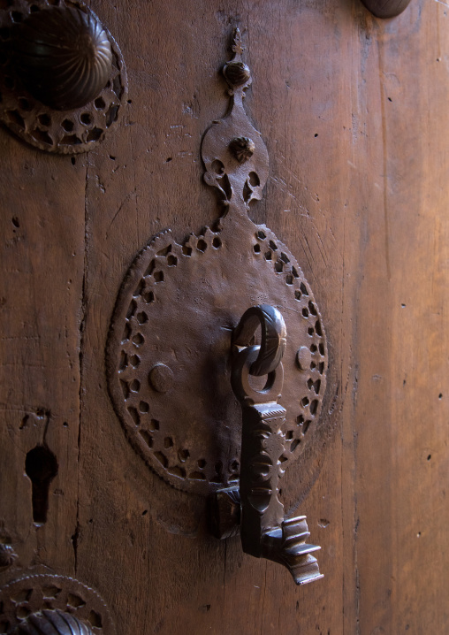 Ancient male doorknocker on a wooden door, Isfahan Province, Kashan, Iran
