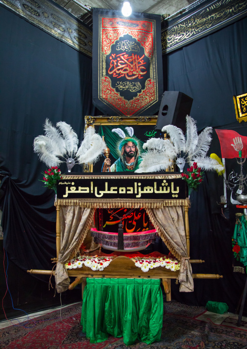 A craddle in the Hosseinieh of the Mad of Hussein for Muharram to commemorate the martyrdom anniversary of Hussein, Isfahan Province, Kashan, Iran