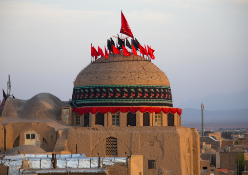 Red and black flags on a shrine decorated for Muharram, Isfahan Province, Kashan, Iran