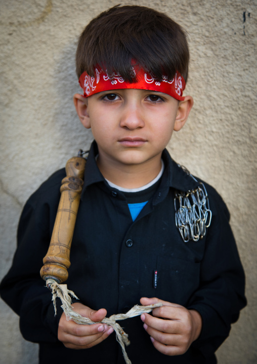 Portrait of an iranian shiite boy with iron chains during the Chehel Manbar ceremony a day before Ashura, Lorestan Province, Khorramabad, Iran