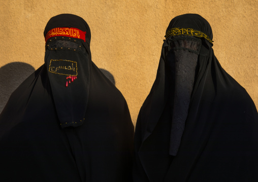 Portrait of iranian shiite muslim women with their faces hidden by a veil mourning Imam Hussein on Tasua during the Chehel Manbar ceremony one day before Ashura, Lorestan Province, Khorramaba